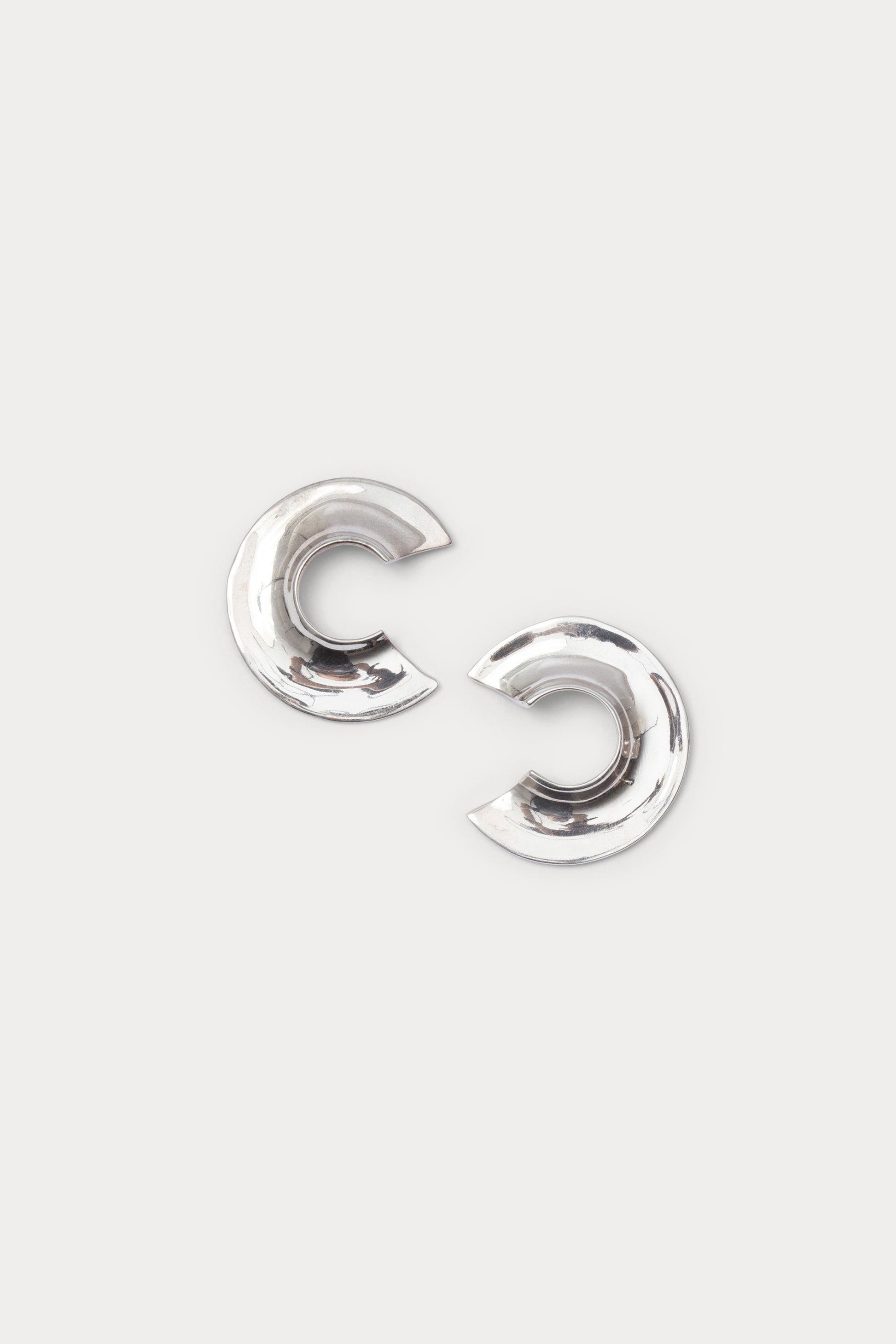 Pair of silver earrings on a white background