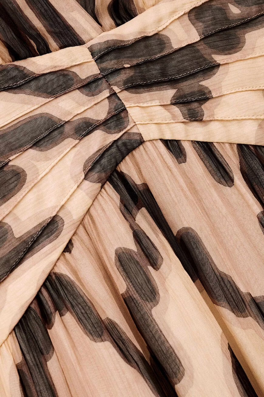 Close-up of a fabric with a leopard print pattern on a beige background