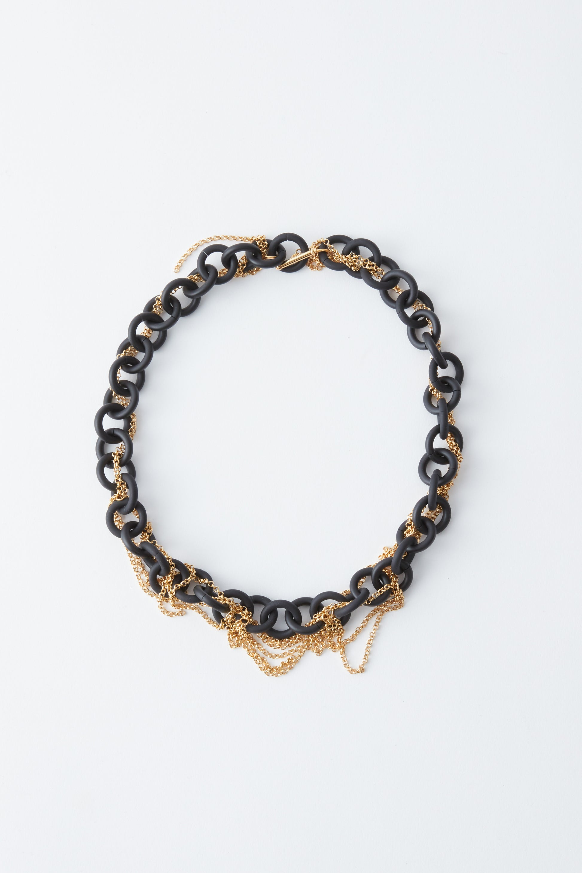 Black and gold necklace on a white background