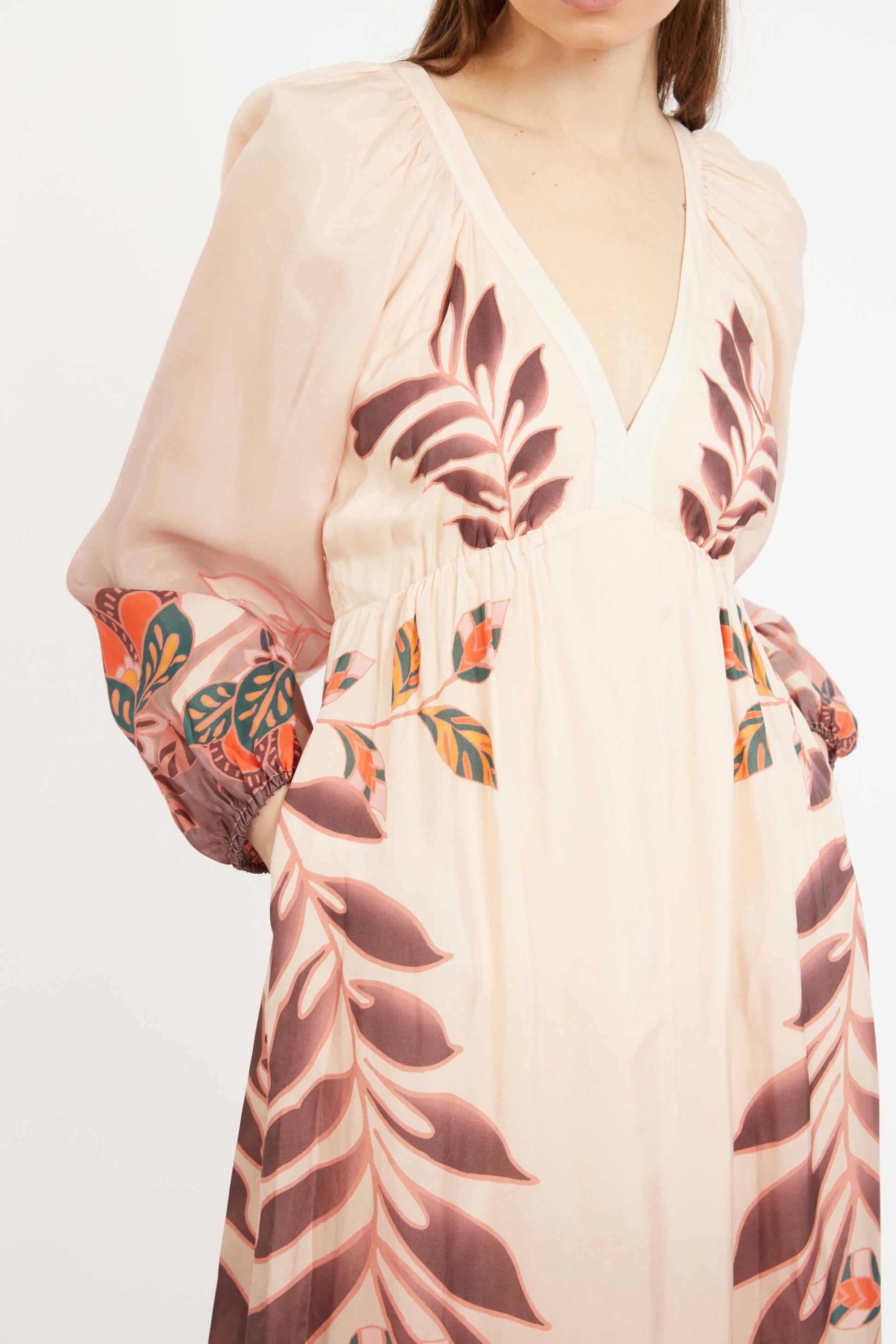 Beige dress with leaf pattern on a plain background