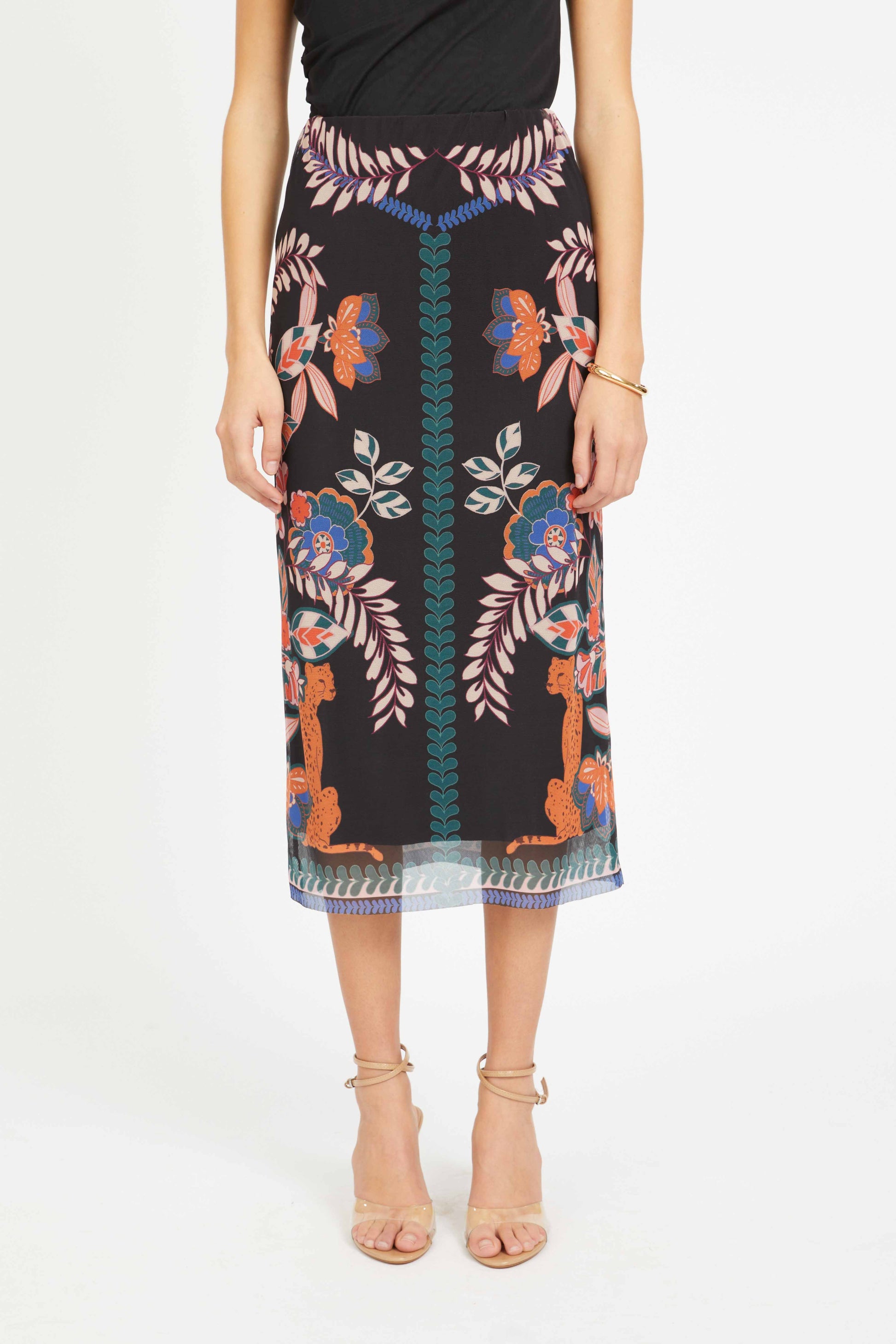 Person wearing a patterned skirt with a white background