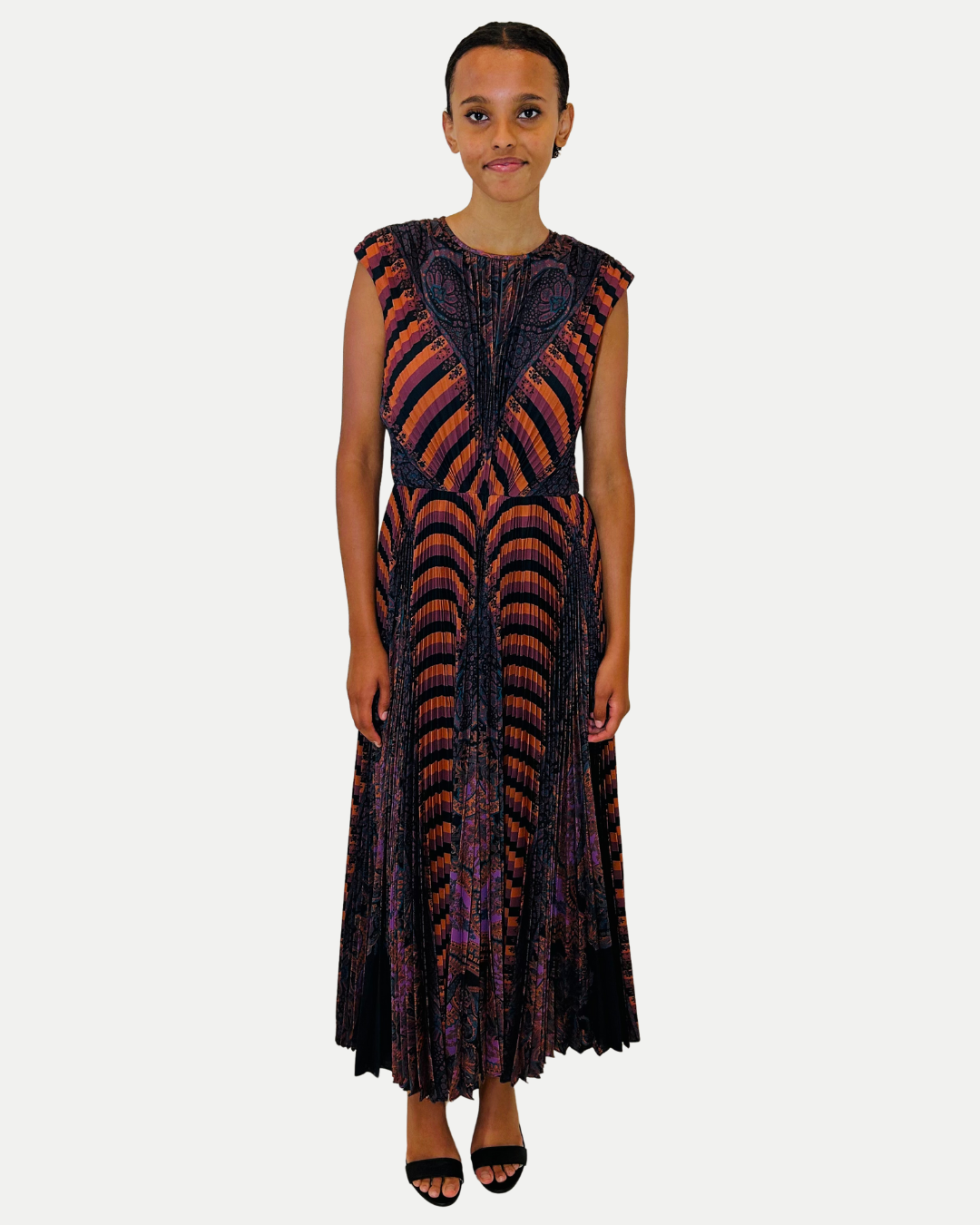 Woman wearing a patterned dress on a white background