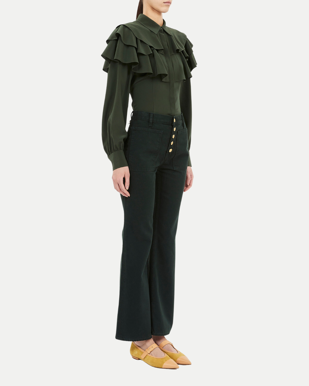 Green ruffled blouse and black pants on a white background