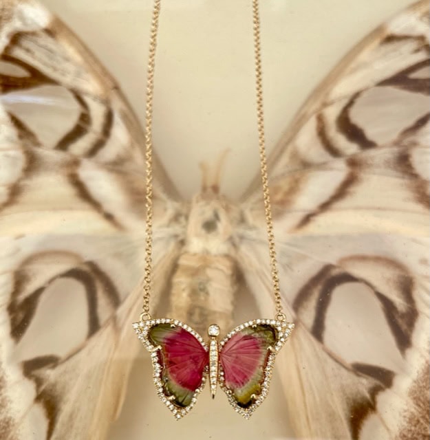 Gold necklace with a watermelon tourmaline butterfly pendant edged in diamonds