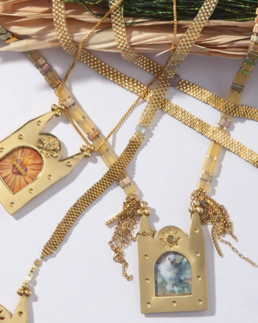 Gold mesh-chain necklaces with arched sacred-heart and cloud pendant charms