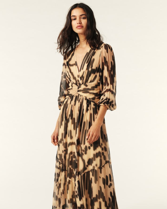 Woman wearing a patterned dress on a white background