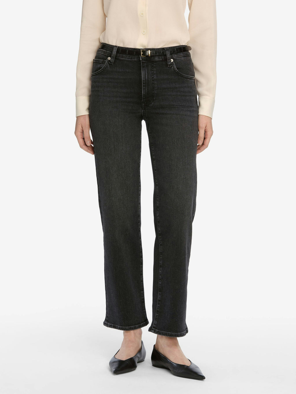 Person wearing black jeans on a white background