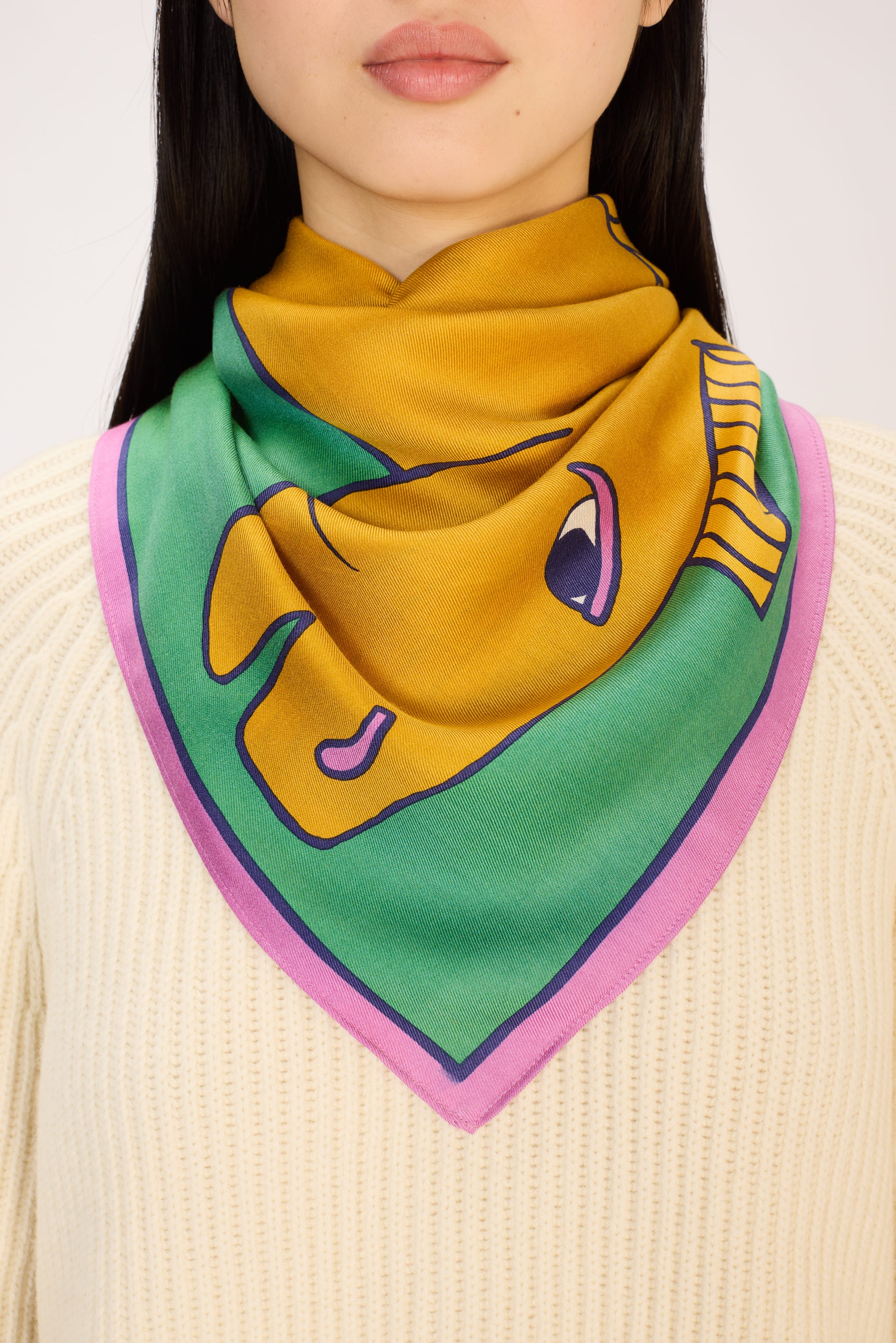 Person wearing a colorful scarf with a cartoon character design on a white background