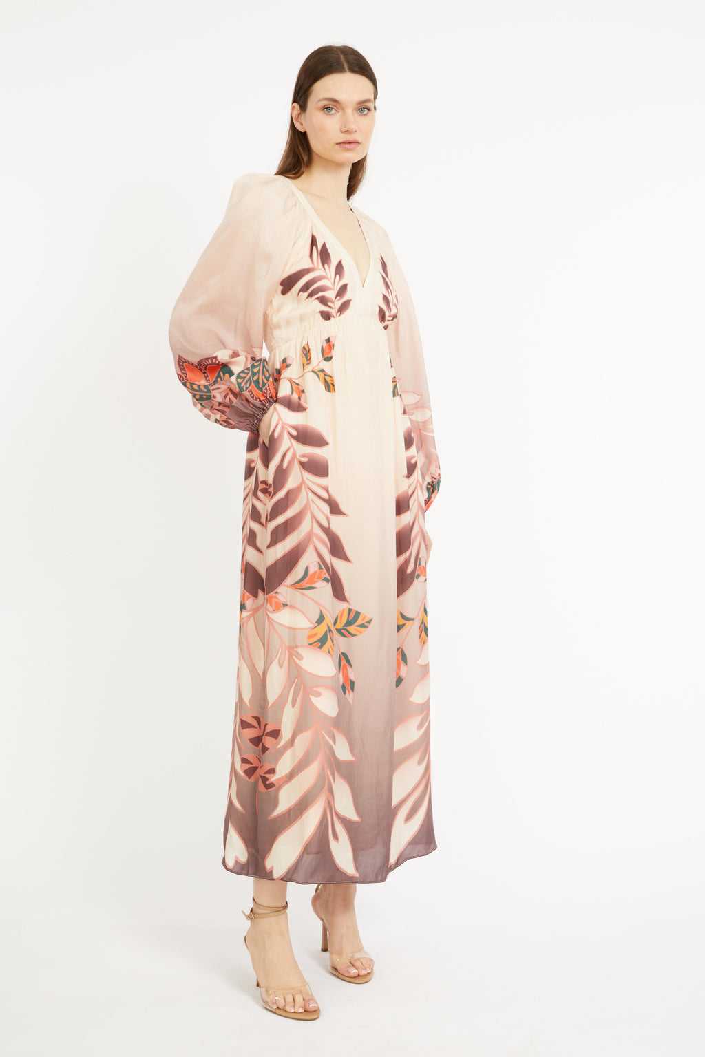 Woman wearing a floral kimono-style garment on a white background