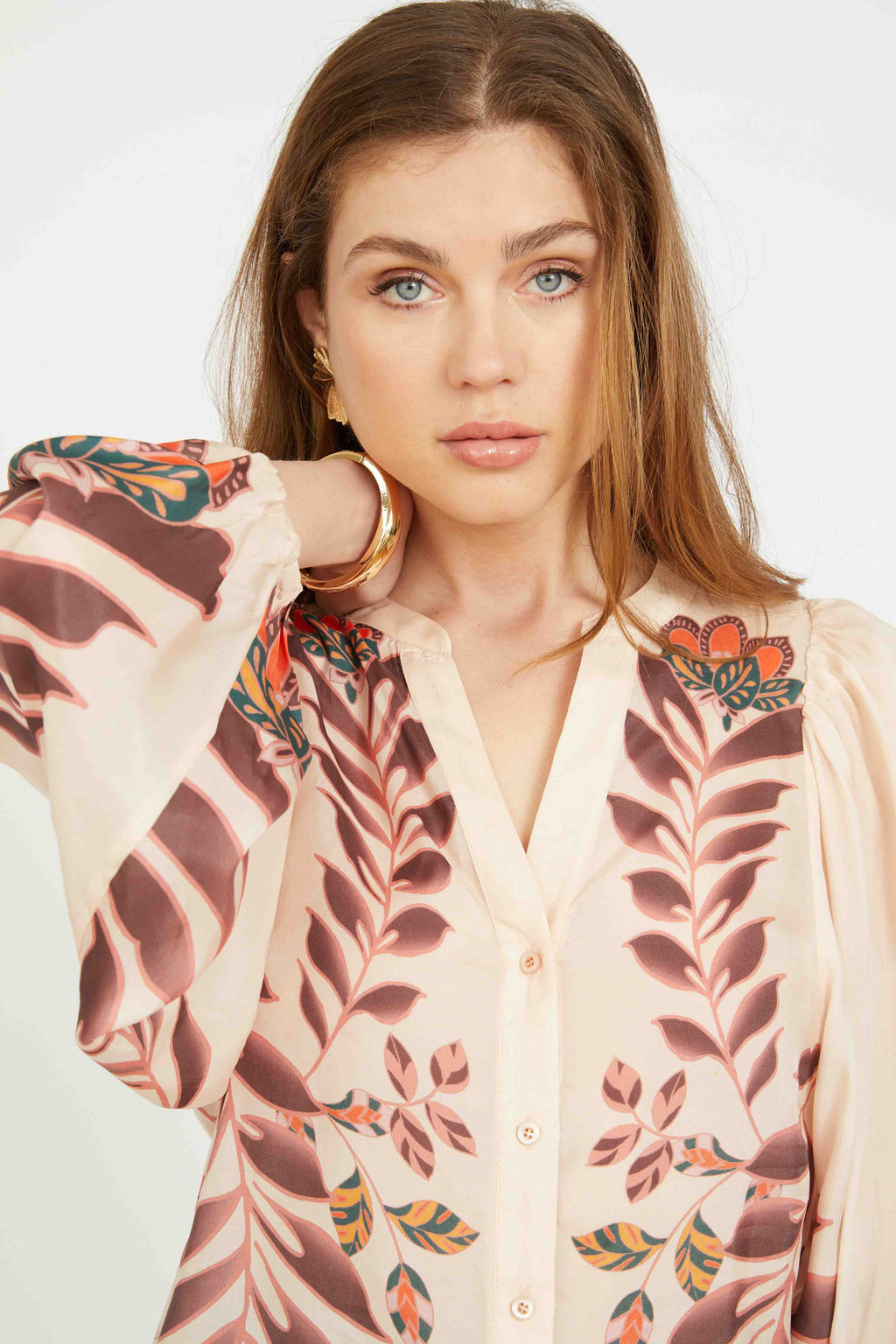 Woman wearing a floral kimono-style garment with a plain background