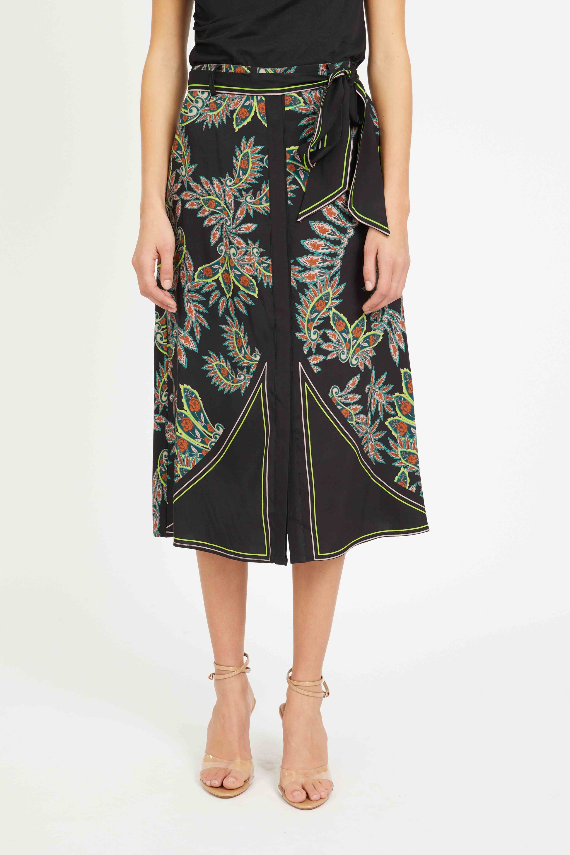 Black skirt with colorful floral patterns worn by a person on a white background