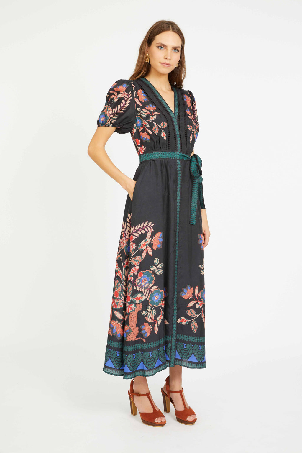 Woman wearing a black floral dress on a white background