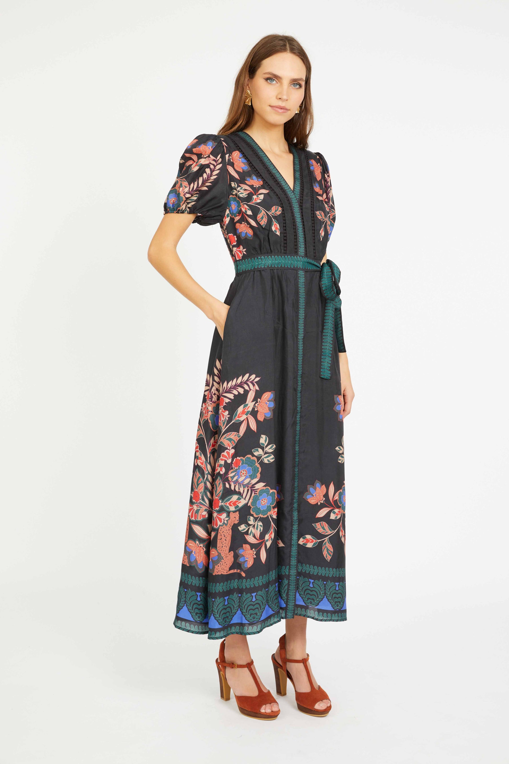 Woman wearing a black floral dress on a white background