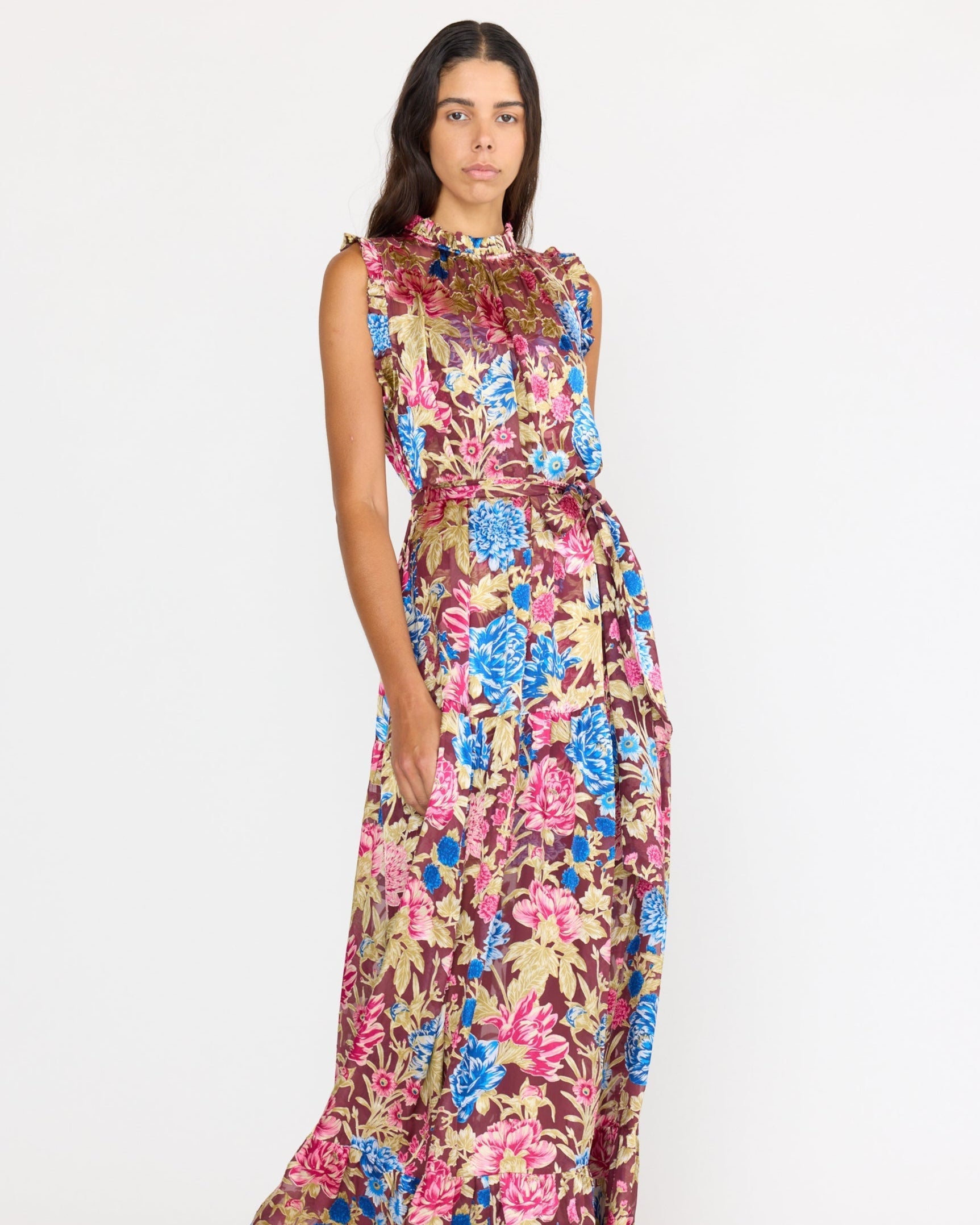 Woman wearing a colorful floral dress on a white background