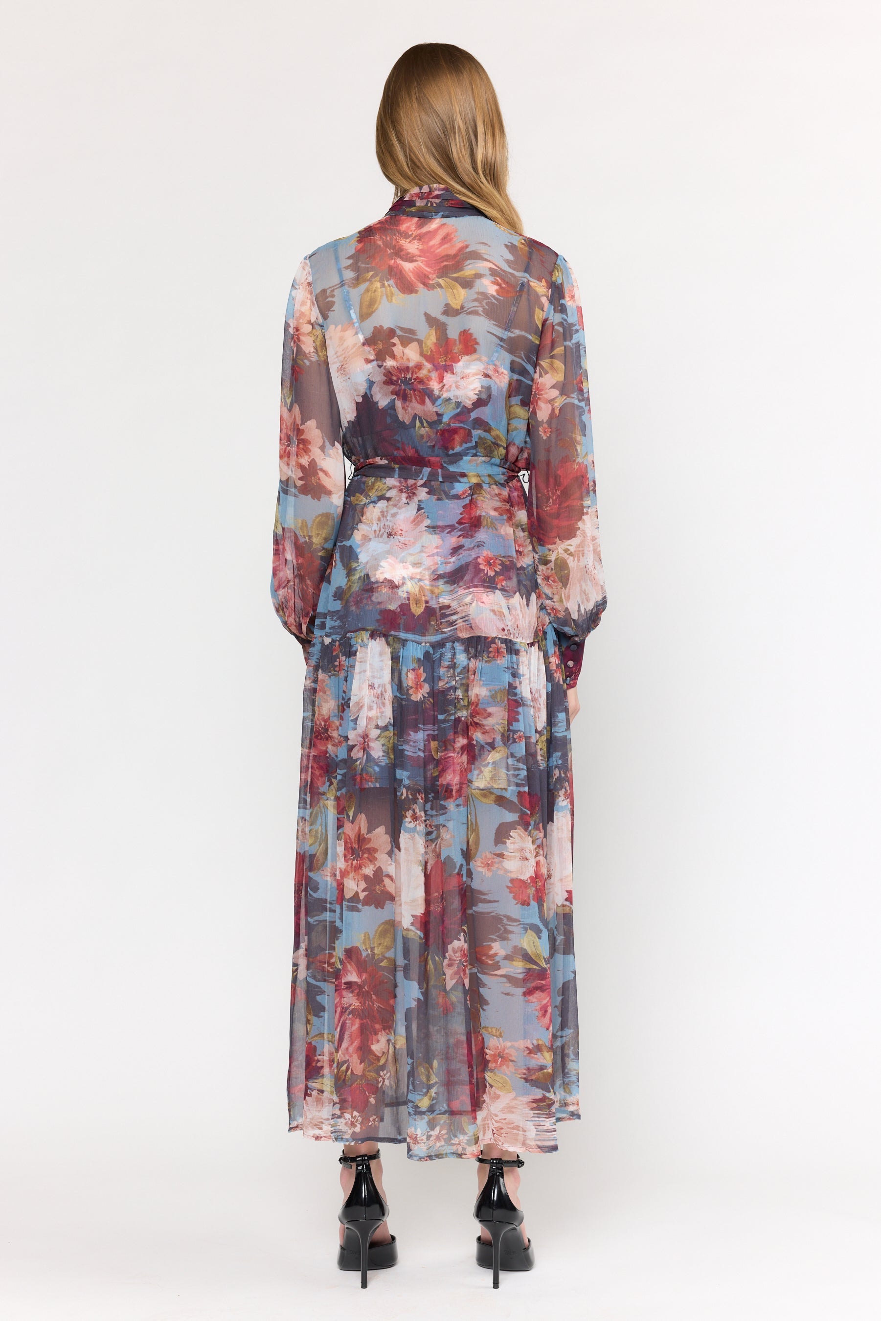 Woman wearing a floral dress with a white background