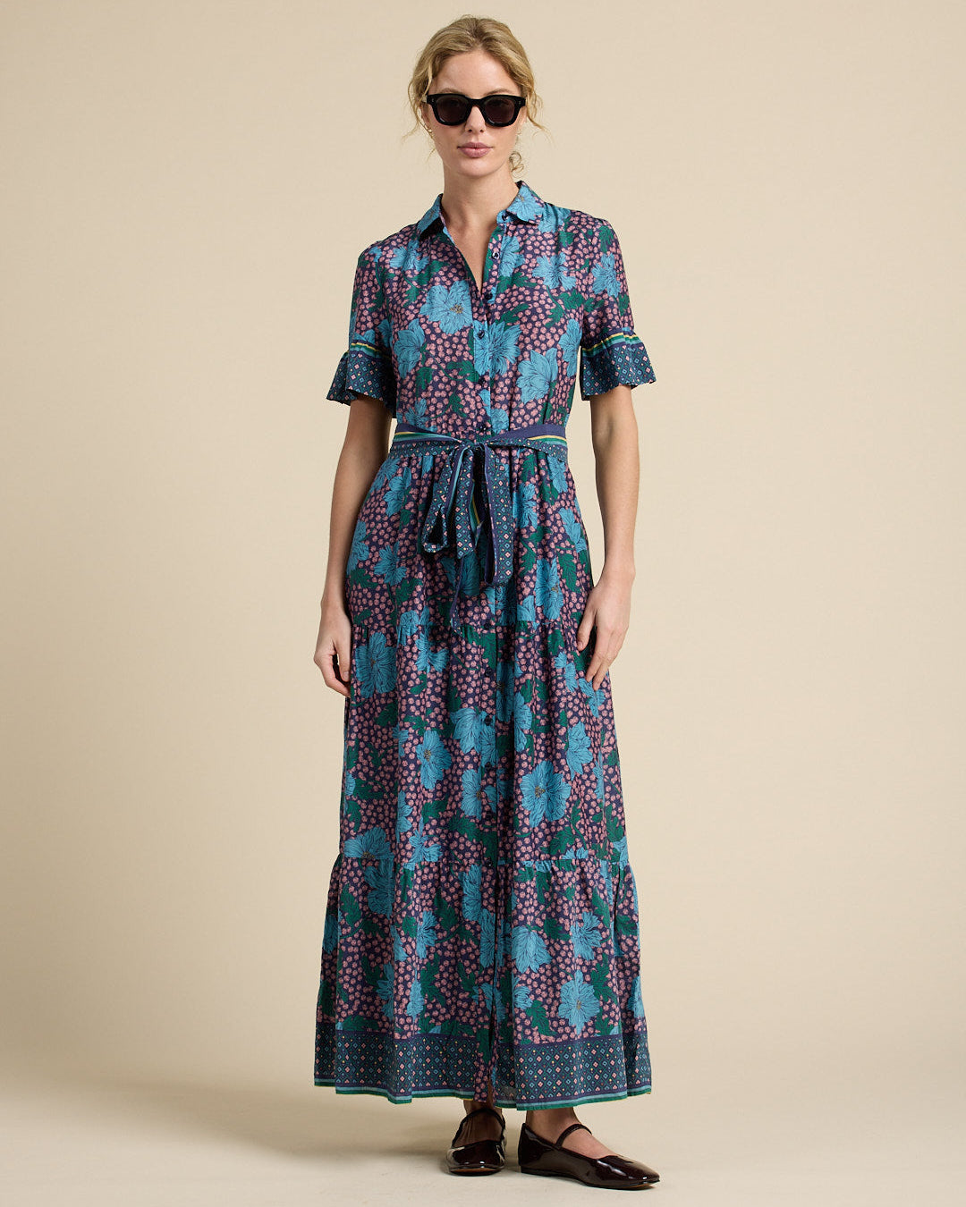 Woman wearing a patterned dress on a beige background