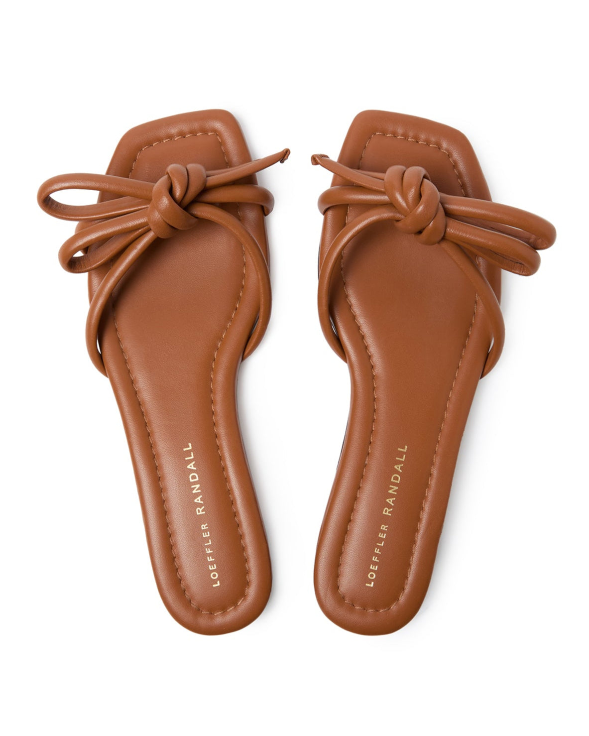Pair of brown sandals with knot detail on a white background