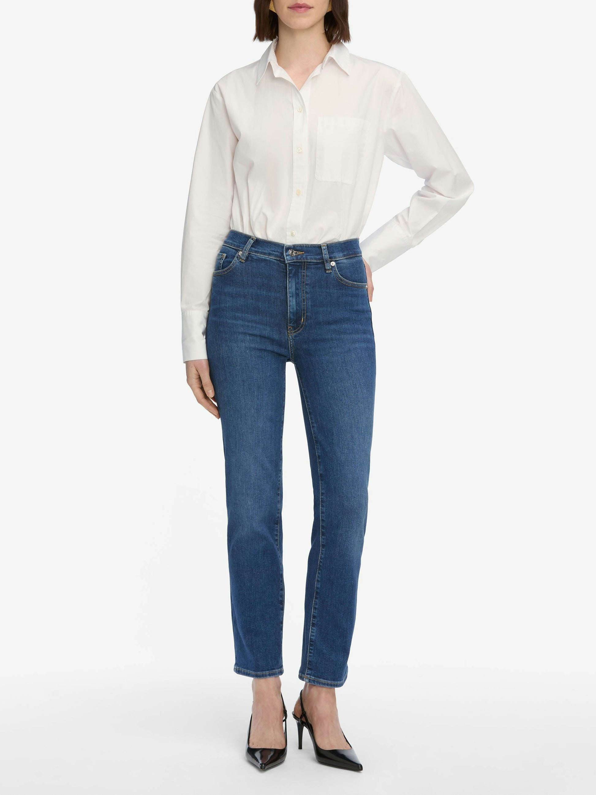 Person wearing a white shirt and blue jeans on a white background