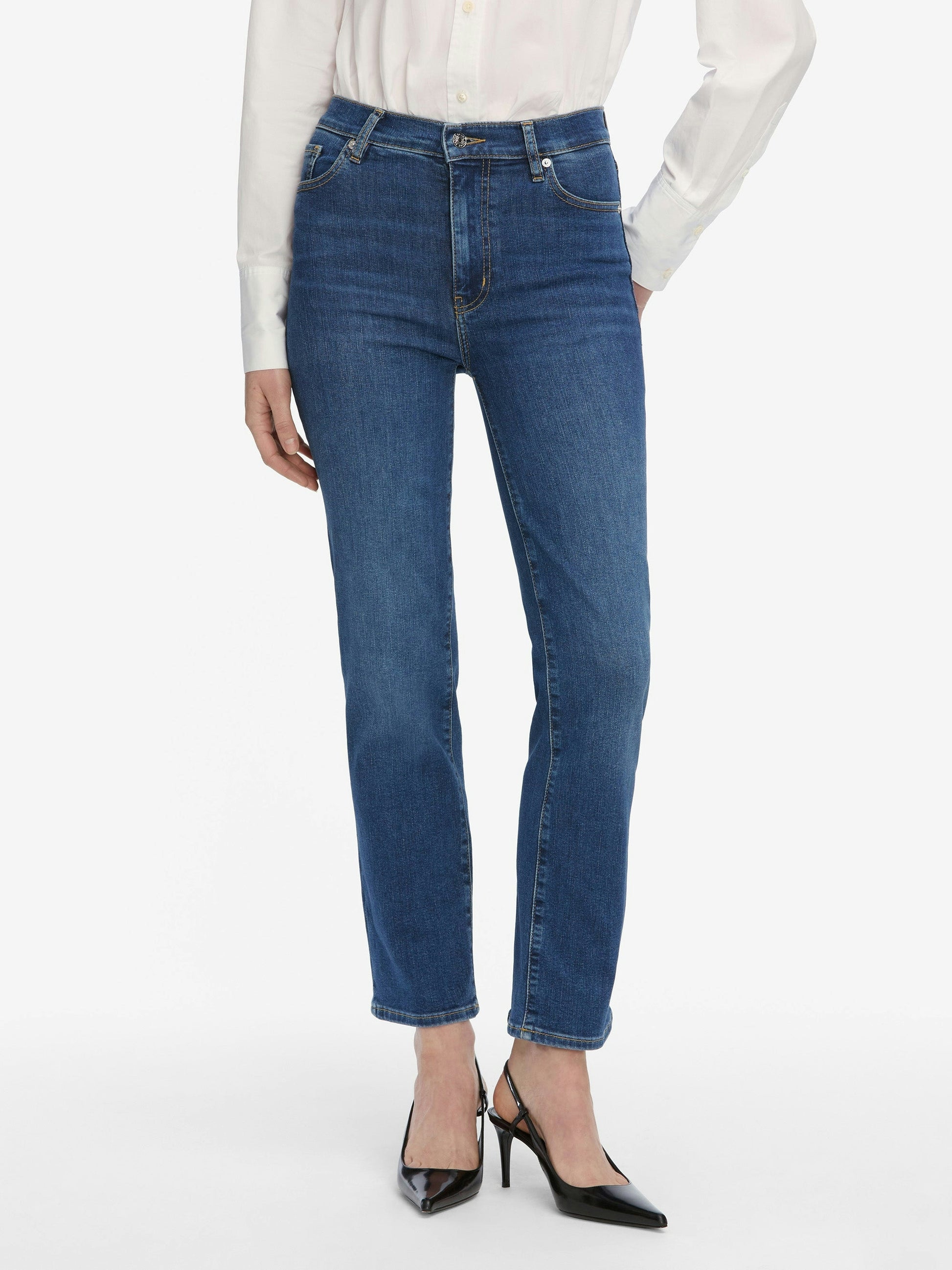 Blue jeans worn by a person on a white background