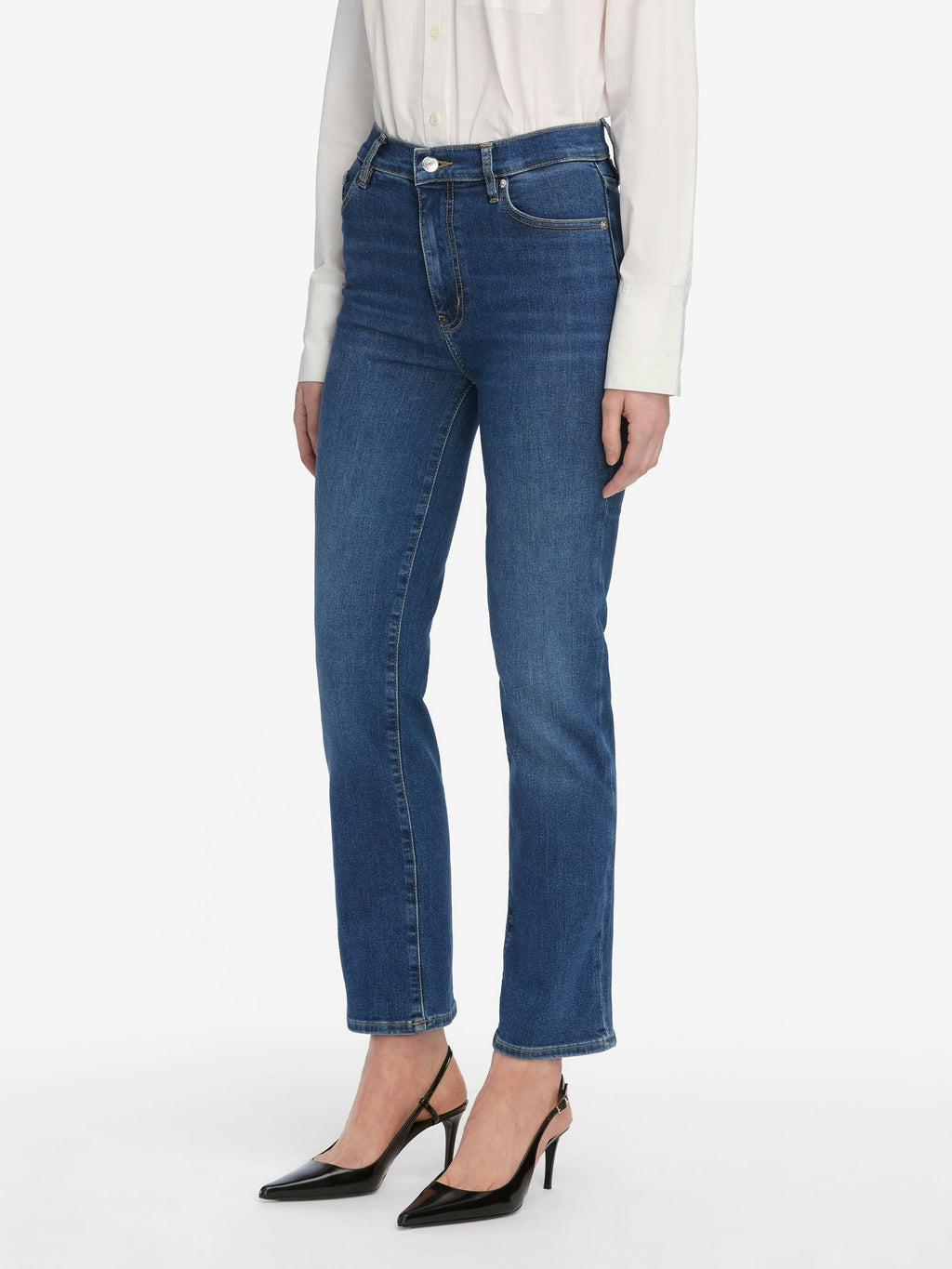 Person wearing blue jeans on a white background