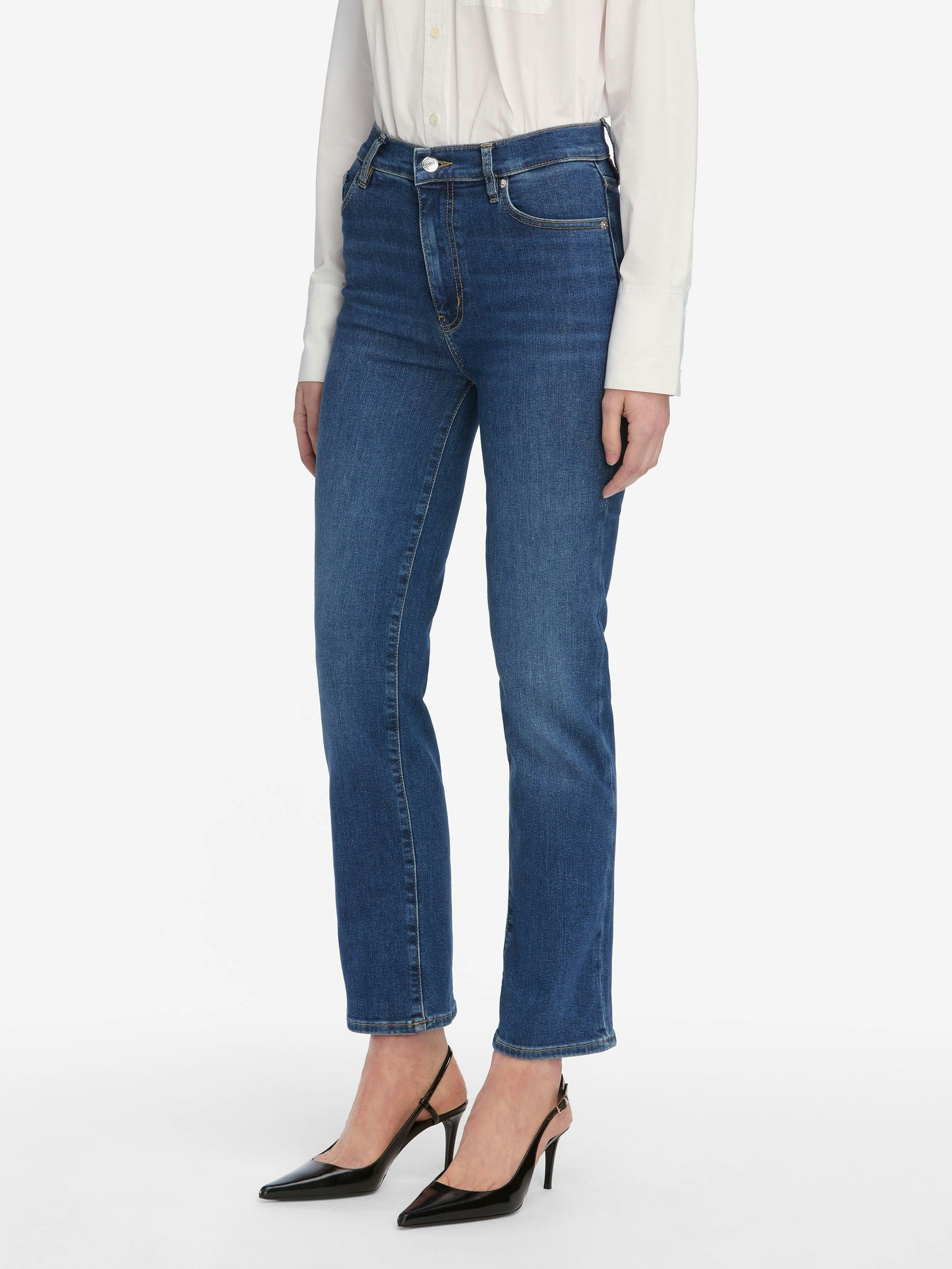 Person wearing blue jeans on a white background