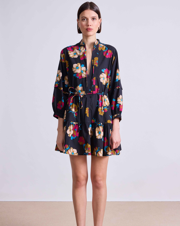 Woman wearing a floral dress on a plain background
