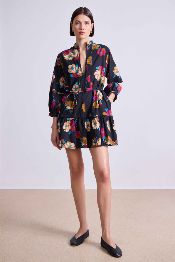 Woman wearing a floral dress with a plain background