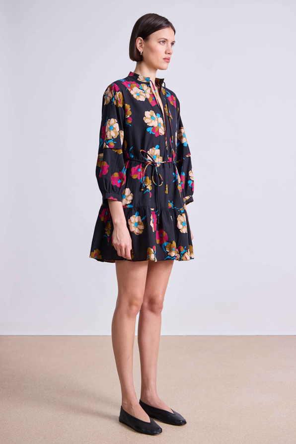 Woman wearing a floral dress on a plain background