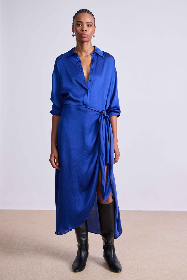 Woman wearing a blue dress with a plain background