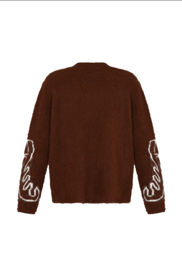 Brown sweater with white patterns on sleeves against a white background