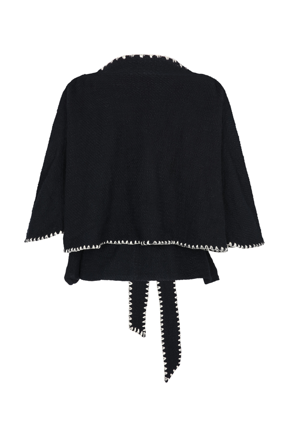 Black cape with decorative trim on a white background