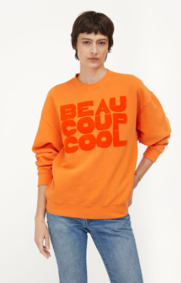 Person wearing an orange sweatshirt with 'BEAU COUP COOL' text on a white background