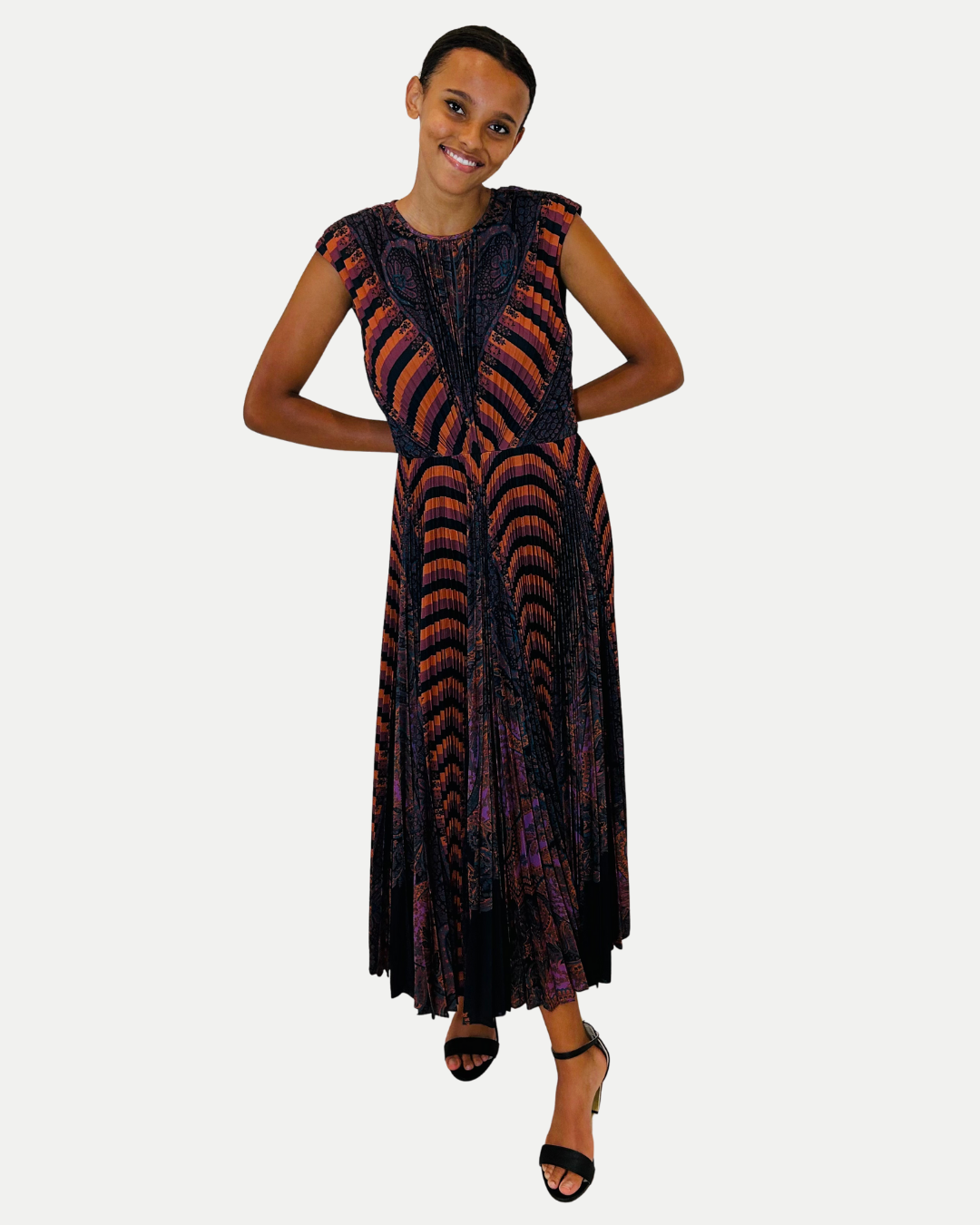 Woman wearing a patterned dress on a white background