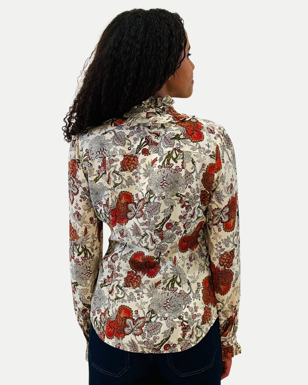 Woman wearing a floral patterned blouse on a white background