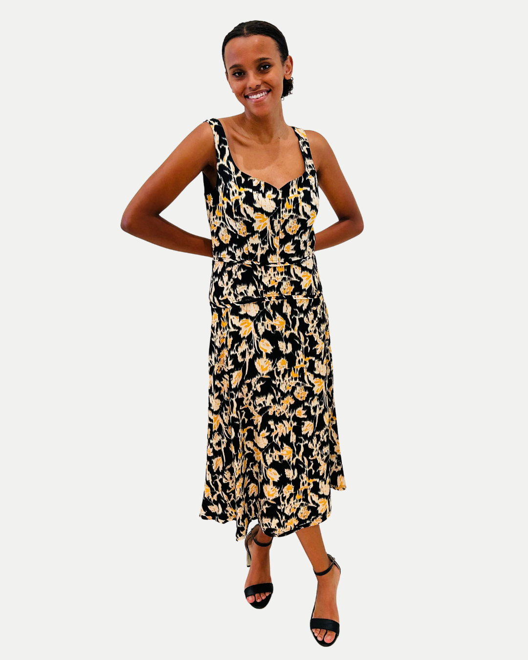 Woman wearing a black floral dress on a white background