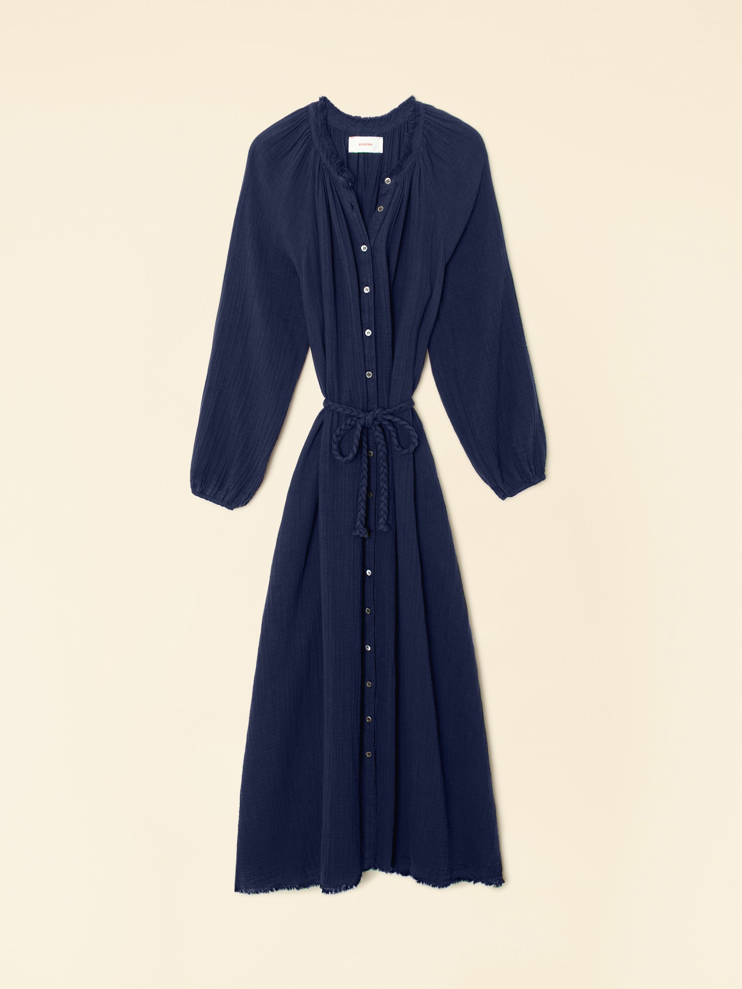 Navy blue dress with long sleeves on a beige background