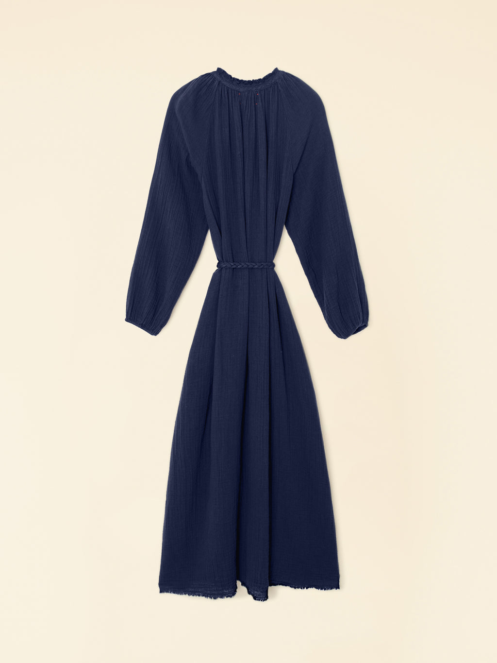 Navy blue dress with long sleeves on a beige background