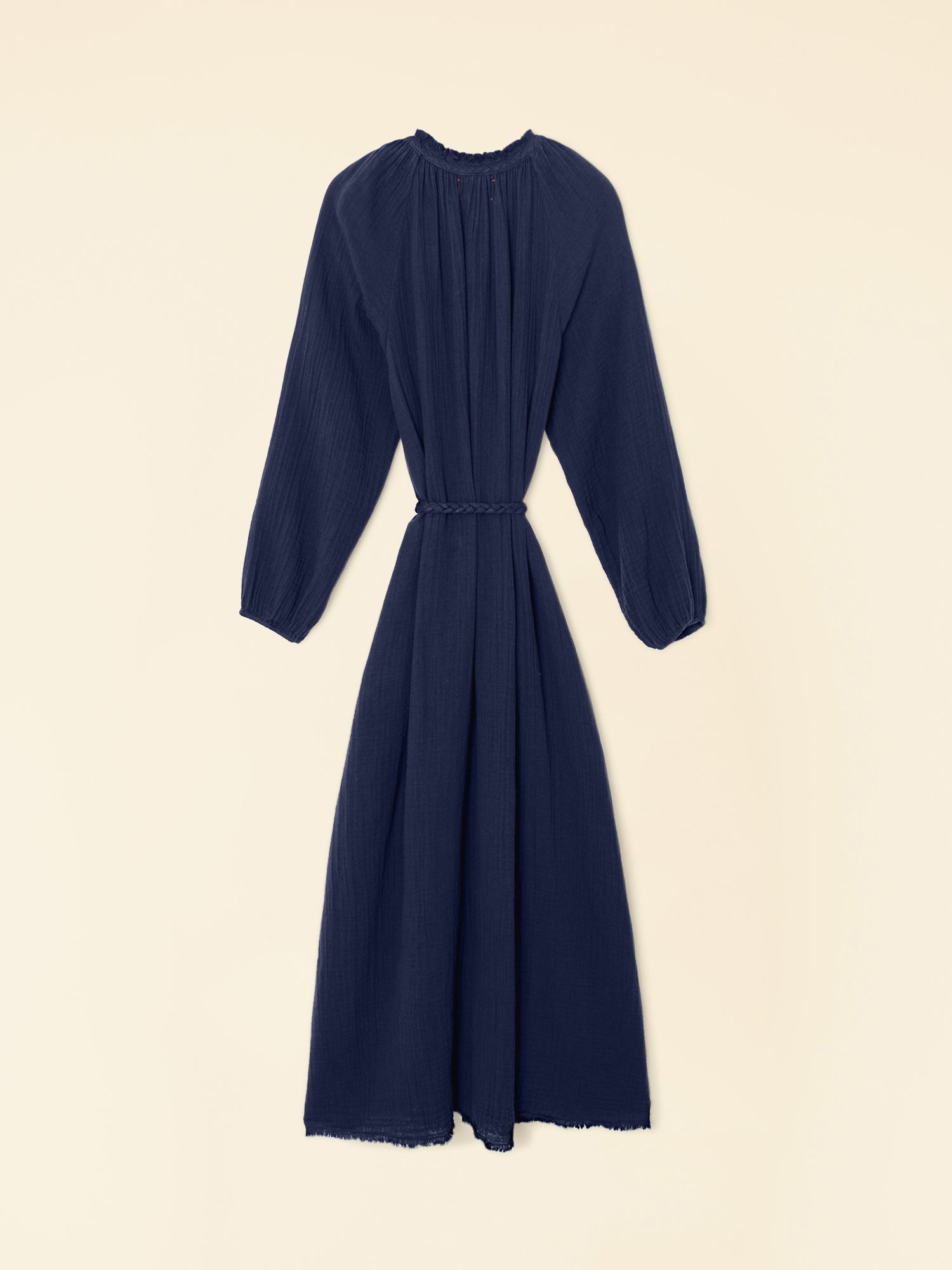 Navy blue dress with long sleeves on a beige background