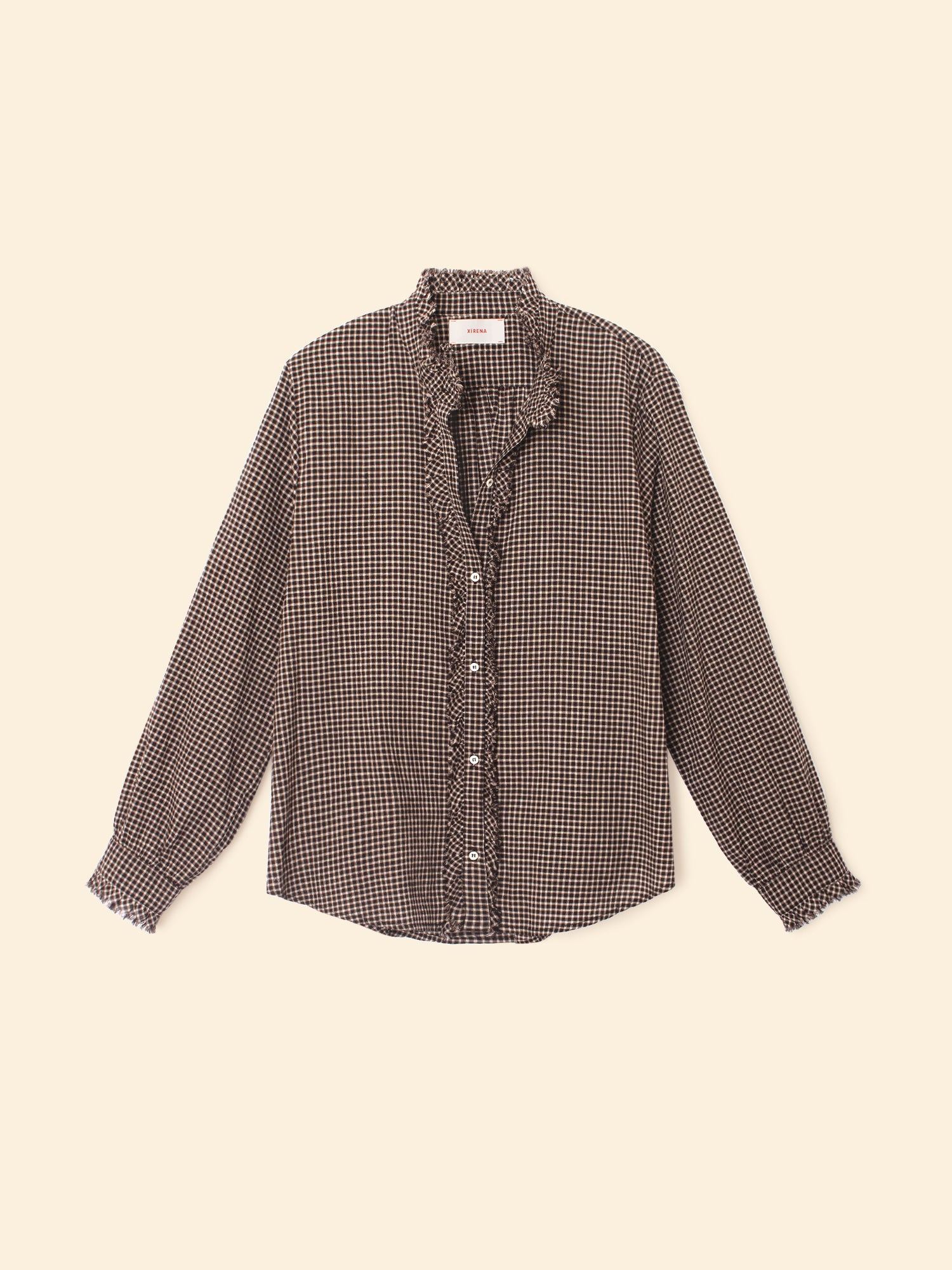 Checkered shirt with ruffled collar on a beige background