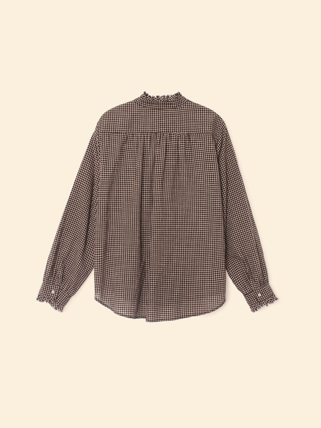 Checkered blouse on a beige background
