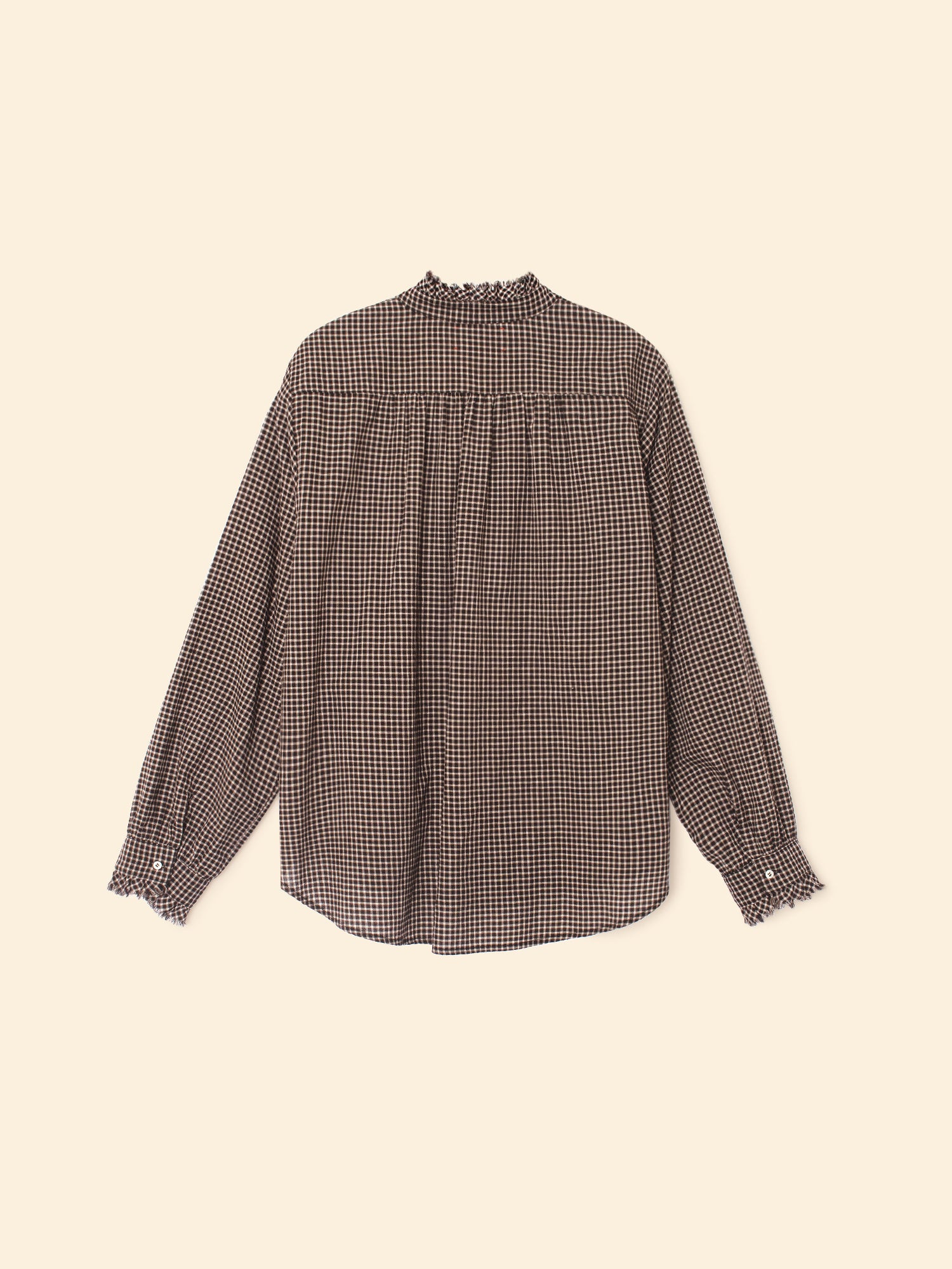 Checkered blouse on a beige background