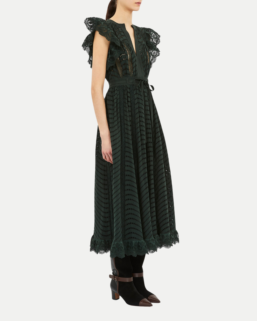 Woman wearing a dark green lace dress on a white background