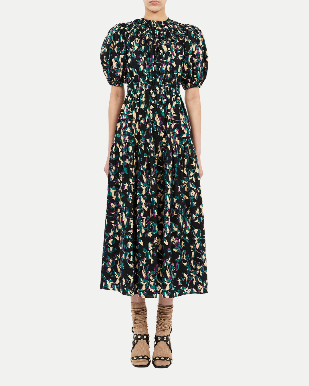 Woman wearing a patterned dress on a white background