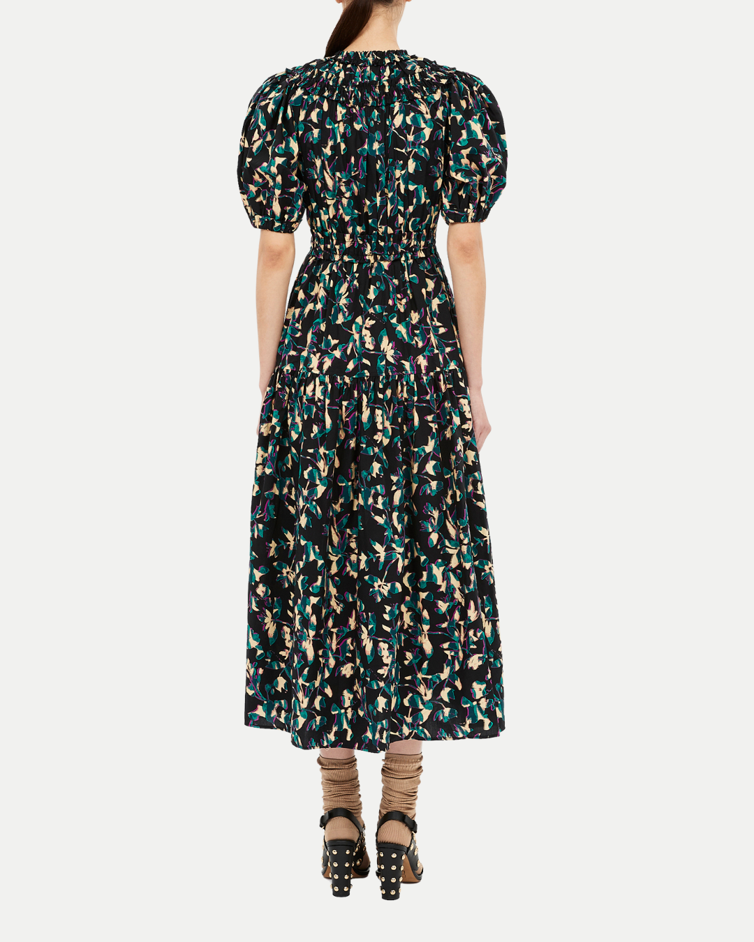 Woman wearing a patterned dress on a white background