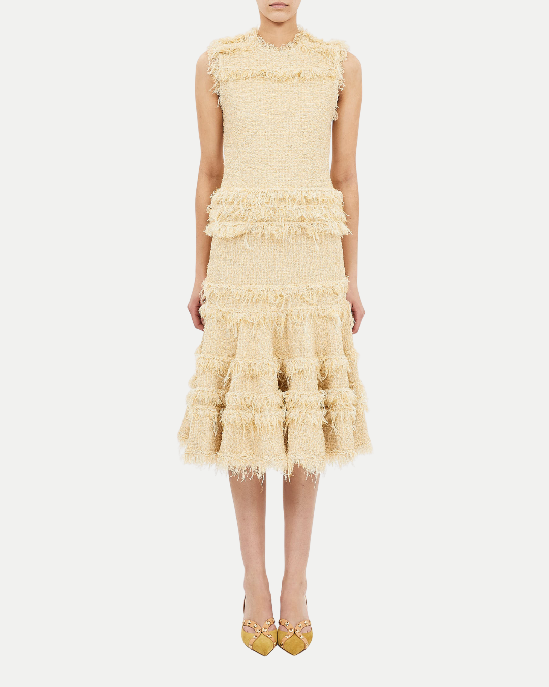 Yellow dress with ruffled layers on a white background